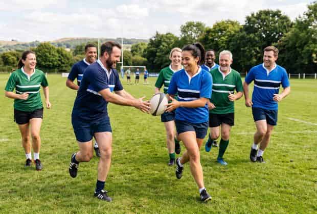 Colleghi che si passano la palla durante un team building rugby